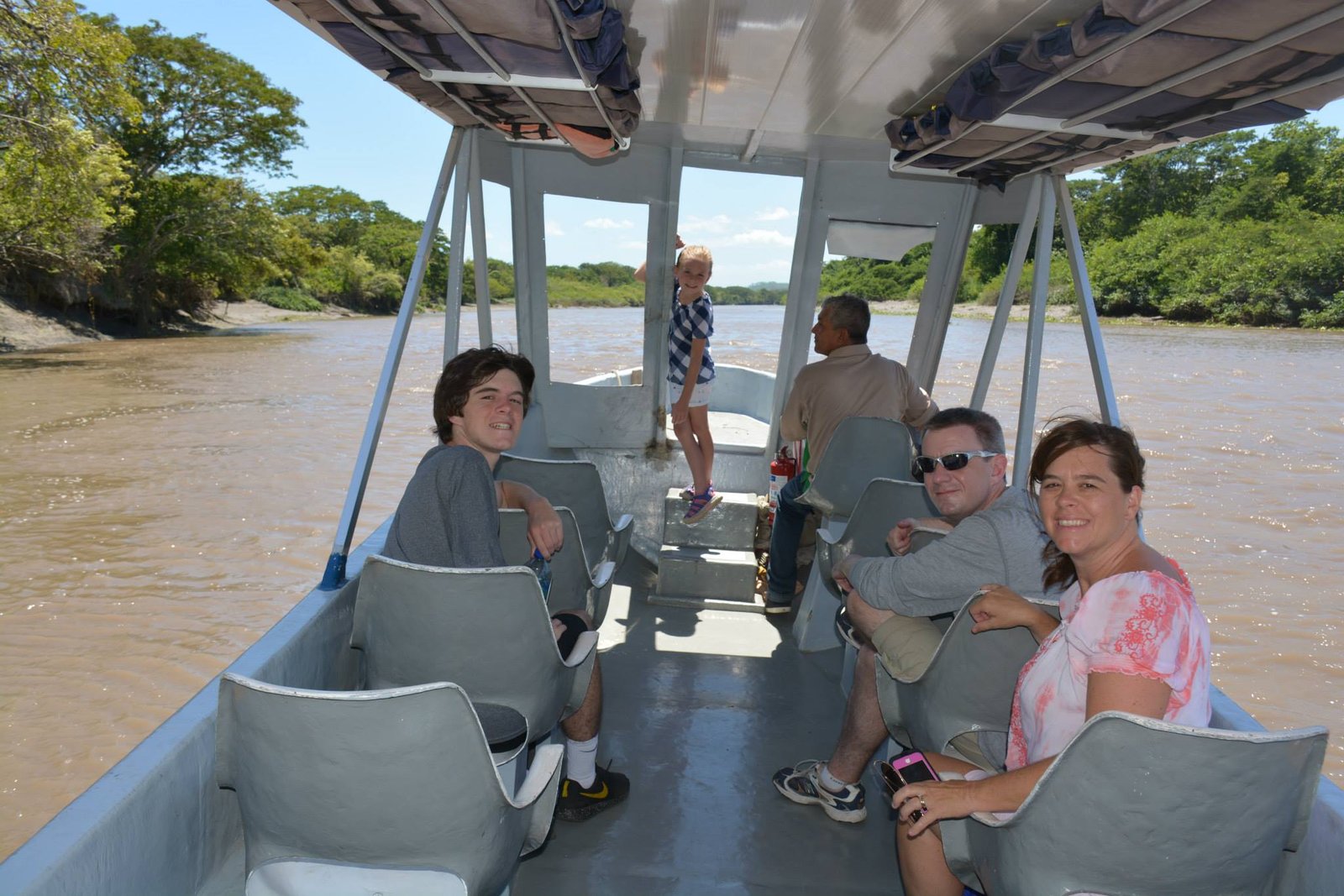 "Guided boat tour through the wetlands of Palo Verde National Park, showcasing diverse wildlife and stunning landscapes, with lush vegetation and birds in flight."