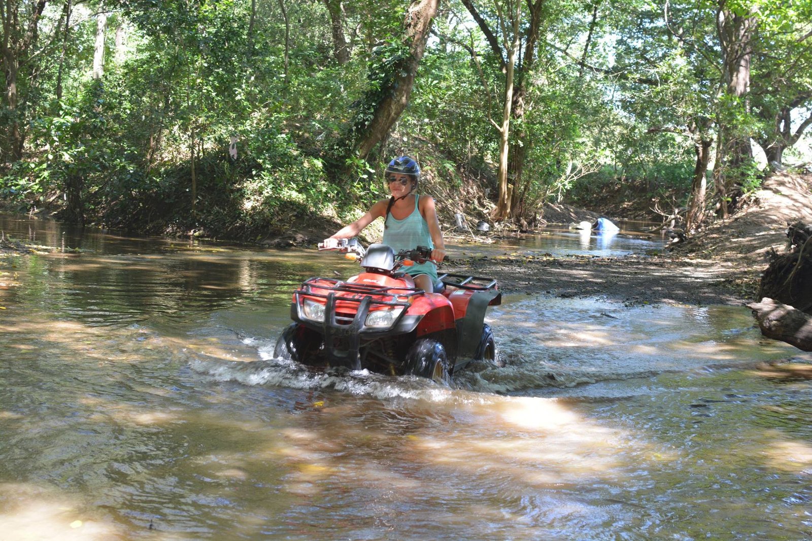 "Riders exploring the rugged trails near Tamarindo Beach on an ATV, with stunning ocean views and lush tropical scenery in the background."