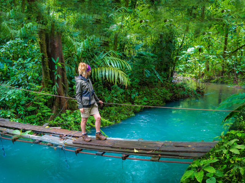"Stunning turquoise waters of Rio Celeste, with lush rainforest surrounding the river, showcasing the unique natural beauty of Costa Rica's national park."