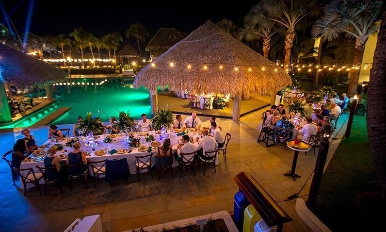 "View of Tamarindo Airport, with a small runway and tropical vegetation surrounding the area. The clear blue sky reflects the warm weather, and a few light aircraft are visible on the tarmac, typical for this regional airport in Costa Rica."