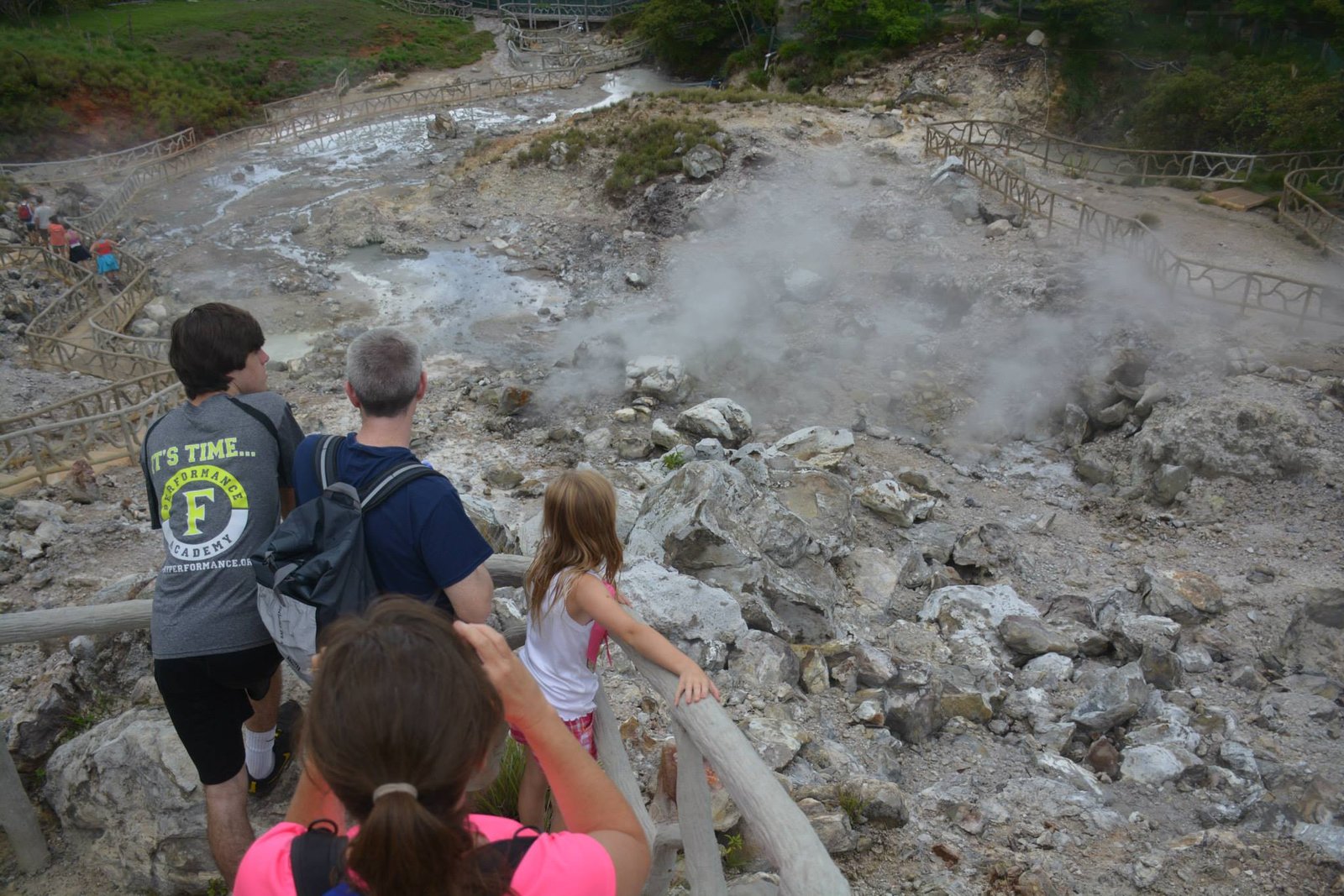 "Scenic view of Miravalles Waterfalls surrounded by lush green forest, with crystal-clear water cascading down rocky cliffs into a serene pool below."