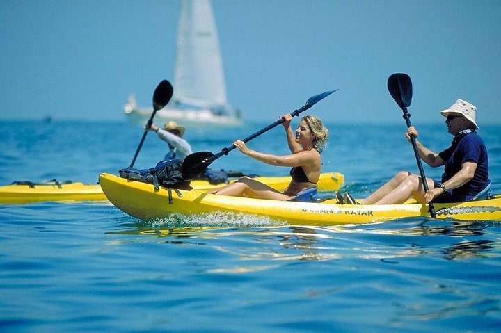 "Scenic sailing tour at Flamingo Beach, Costa Rica, with stunning ocean views, a sailboat gliding through calm waters, and a vibrant sunset in the background."